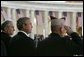 President George W. Bush stands with Secretary of Veterans Affairs Anthony Principi, left, and Mr. Gene Overstreet, President of the Non-Commissioned Officers Association, during the Veterans Day ceremonies at Arlington National Cemetery Nov. 11, 2004. "We honor every soldier, sailor, airman, Marine and Coastguardsman who gave some of the best years of their lives to the service of the United States and stood ready to give life, itself, on our behalf," said the President in his remarks. White House photo by Paul Morse