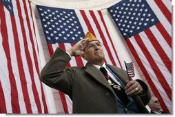 A veteran listens as President Bush speaks during ceremonies honoring Veterans Day at Arlington National Cemetery Nov. 11, 2004. "Our veterans are drawn from several generations and many backgrounds. They're Americans who remember the swift conflict of the Persian Gulf War; and a long Cold War vigil; the heat of Vietnam and the bitter cold of Korea. They are veterans in their 80s, who served under MacArthur and Eisenhower and saved the liberty of the world," said the President. White House photo by Paul Morse