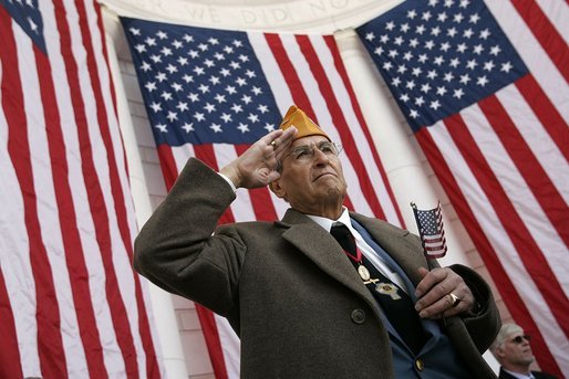 A veteran listens as President Bush speaks during ceremonies honoring Veterans Day at Arlington National Cemetery Nov. 11, 2004. "Our veterans are drawn from several generations and many backgrounds. They're Americans who remember the swift conflict of the Persian Gulf War; and a long Cold War vigil; the heat of Vietnam and the bitter cold of Korea. They are veterans in their 80s, who served under MacArthur and Eisenhower and saved the liberty of the world," said the President. White House photo by Paul Morse