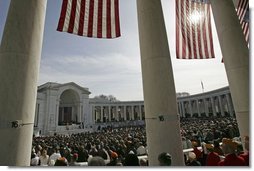 President George W. Bush honors Veterans Day in a speech at Arlington National Cemetery Nov. 11, 2004. "Twenty-five million military veterans walk among us, and on this day, our nation thanks them all," said the President. "These are the hidden heroes of a peaceful nation: our colleagues and friends, neighbors and family members who answered the call and returned to live in the land they defended." White House photo by Tina Hager