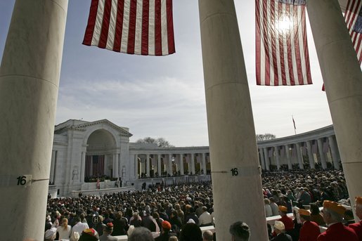 President George W. Bush honors Veterans Day in a speech at Arlington National Cemetery Nov. 11, 2004. "Twenty-five million military veterans walk among us, and on this day, our nation thanks them all," said the President. "These are the hidden heroes of a peaceful nation: our colleagues and friends, neighbors and family members who answered the call and returned to live in the land they defended." White House photo by Tina Hager