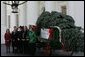 Laura Bush receives the official White House Christmas tree delivered on a horse drawn wagon Monday, Nov. 29. 2004. The 18.5 foot Noble fir donated by John and Carol Tillman of Rochester, Wash., will be decorated and displayed in the Blue Room. White House photo by Susan Sterner