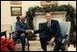 President George W. Bush meets with President Abdoulaye Wade of Senegal in the Oval Office, Monday, Dec. 6, 2004. White House photo by Tina Hager