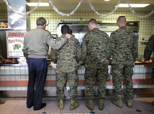 President George W. Bush stands in a chow line with Marines before sitting down for lunch with military personnel at Marine Corps Base Camp Pendleton, Calif., Tuesday, Dec. 7, 2004.White House photo by Eric Draper