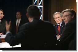 President George W. Bush listens to Time Warner CEO Richard Parsons, center, during a White House economic conference at the Ronald Reagan Building and International Trade Center in Washington, D.C., Thursday, Dec. 16, 2004. Also pictured are, James Glassman, Senior economist at JP Morgan Chase, far left, and former Rep. Tim Penny, D-Minn, right.  White House photo by Paul Morse