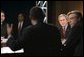 President George W. Bush listens to Time Warner CEO Richard Parsons, center, during a White House economic conference at the Ronald Reagan Building and International Trade Center in Washington, D.C., Thursday, Dec. 16, 2004. Also pictured are, James Glassman, Senior economist at JP Morgan Chase, far left, and former Rep. Tim Penny, D-Minn, right. White House photo by Paul Morse