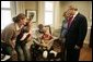 President George W. Bush and Laura Bush talk with U.S. Army Sgt. Dale Beatty of Statesville, N.C., and, from left, sister-in-law Wendolyn Summers, wife Belinda Beatty, son Lucas, 6 months old, and son Dustin, 2 years old, during a visit to the Fisher House at Walter Reed Army Medical Center in Washington, D.C., Tuesday, Dec. 21, 2004. President Bush presented Sgt. Beatty The Purple Heart for injuries he sustained while serving in Operation Iraqi Freedom. White House photo by Paul Morse