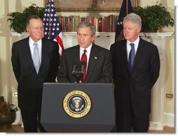 President George W. Bush announces a nationwide charitable fundraising effort to be led by former President George H.W. Bush, left, and former President Bill Clinton to aid victims of last week's earthquake and tsunamis in South Asia in the Roosevelt Room, Monday, January 3, 2005.   White House photo by Tina Hager