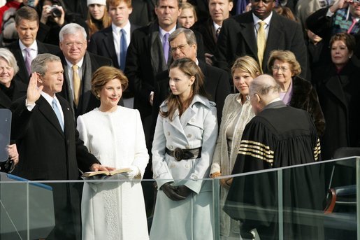 With his left hand resting on a family Bible, President George W. Bush takes the oath of office to serve a second term as 43rd President of the United States during a ceremony at the U.S. Capitol, Thursday, Jan. 20, 2005. Laura Bush, Barbara Bush, and Jenna Bush listen as Chief Justice William H. Rehnquist administers the oath. White House photo by Susan Sterner