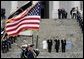 Escorted by Army Major General Galen Jackman, center, President George W. Bush, Laura Bush, Vice President Dick Cheney and Lynne Cheney salute the American flag from the U.S. Capitol steps before President Bush takes the oath of office for a second term as the 43rd President of the United States, Thursday, January 20, 2005. White House photo by Eric Draper