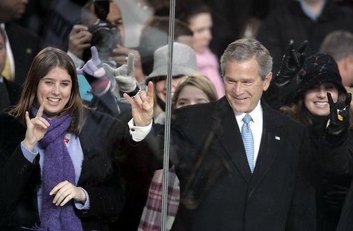 President George W. Bush gestures the 'Hook 'em, horns," the salute of the University of Texas Longhorns, as he watches the Inaugural Parade with his family and friends from the reviewing stand in front of the White House, Thursday, Jan. 20, 2005. White House photo by Paul Morse