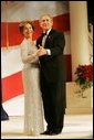 President George W. Bush and Laura Bush dance for the crowd during the Constitution Ball held at the Washington Hilton, Washington, D.C., Thursday, Jan. 20, 2005. White House photo by Susan Sterner