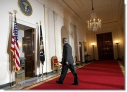 President George W. Bush leaves the podium after delivering a statement on Iraq's elections from the Cross Hall of the White House, Sunday, Jan. 30, 2005.  White House photo by Eric Draper