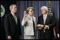 With President George W. Bush and her husband Robert Spellings by her side, Secretary of Education Margaret Spellings takes the oath of office during a ceremony at the Department of Education in Washington, D.C., Monday, Jan. 31, 2005. Secretary Spellings served as an Assistant to the President for Domestic Policy during the first term of the Bush administration. White House photo by Paul Morse.