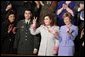 Safia Taleb al-Suhail, leader of the Iraqi Women's Political Council, second on right, displays a peace sign as other guests applaud during President George W. Bush's State of the Union speech at the U.S. Capitol, Wednesday, Feb. 2, 2005. Also pictured are, from left, Kindergarten teacher Lorna Clark of Santa Theresa, New Mexico, Army Staff Sergeant Norbert Lara, and Laura Bush. White House photo by Paul Morse