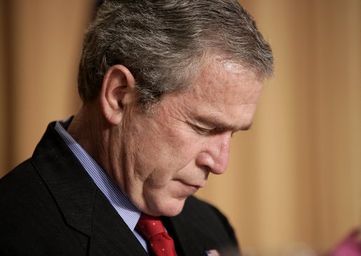 President George W. Bush bows his head in prayer during the National Prayer Breakfast in Washington, D.C., Thursday, Feb. 3, 2005. White House photo by Paul Morse