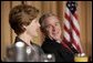 President George W. Bush and Laura Bush laugh during the National Prayer Breakfast in Washington, D.C., Thursday, Feb. 3, 2005. White House photo by Paul Morse