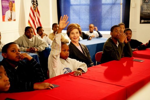 Laura Bush listens as boys participating in the Passport to Manhood program share ideas about respect and love during a visit to the Germantown Boys and Girls Club Tuesday, Feb. 3, 2005 in Philadelphia. Passport to Manhood promotes and teaches responsibility through a series of male club members ages 11-14. White House photo by Susan Sterner