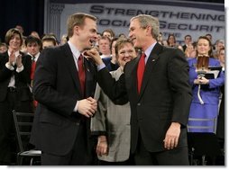 President George W. Bush shares a laugh with Dr. Jeffery Brown, Assistant Professor of the Finance Department at the University of Illinois at Urbana-Champaign, during a discussion on Social Security reform in Fargo, N.D., Thursday, Feb. 3, 2005. Also pictured, center, is conversation participant Mary Bond, a retired worker.  White House photo by Eric Draper