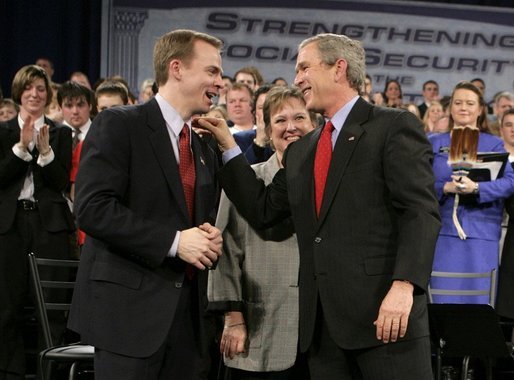 President George W. Bush shares a laugh with Dr. Jeffery Brown, Assistant Professor of the Finance Department at the University of Illinois at Urbana-Champaign, during a discussion on Social Security reform in Fargo, N.D., Thursday, Feb. 3, 2005. Also pictured, center, is conversation participant Mary Bond, a retired worker. White House photo by Eric Draper