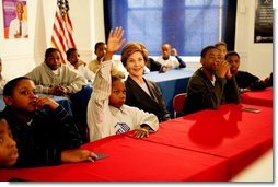 Laura Bush listens as boys participating in the Passport to Manhood program share ideas about respect and love during a visit to the Germantown Boys and Girls Club Tuesday, Feb. 3, 2005 in Philadelphia. Passport to Manhood promotes and teaches responsibility through a series of male club members ages 11-14.  White House photo by Susan Sterner