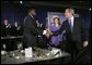 President George W. Bush greets Detroit Mayor Kwame Kilpatrick after delivering remarks at the Detroit Economic Club in Detroit, Michigan, Tuesday, Feb. 8, 2005. Also pictured at center is Detroit Economic Club President Beth Chappell. White House photo by Eric Draper