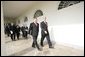 President George W. Bush and Aleksander Kwasniewski, the President of Poland, walk along the colonnade to the Oval Office Wednesday, Feb. 9, 2005. White House photo by Eric Draper