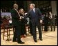 President George W. Bush greets his fellow stage participants during a Town Hall meeting on strengthening Social Security in Raleigh, N.C., Thursday, Feb. 10, 2005. White House photo by Eric Draper