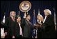 Justice Sandra Day O'Connor offers Alberto Gonzales the oath of office Monday, Feb. 14, 2005, during his ceremonial swearing-in at the Justice Department. With President George W. Bush looking on are Mr. Gonzales's mother, Maria, and wife, Becky. White House photo by Paul Morse.