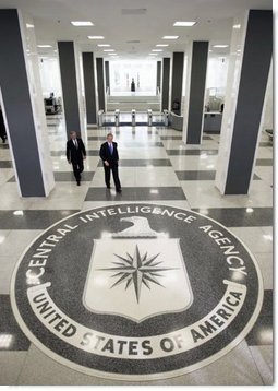 Walking through the main lobby, President George W. Bush and Porter Goss, director of the Central Intelligence Agency, head to a brief news conference at CIA headquarters Thursday, March 3, 2005, in Langley, Va.  White House photo by Paul Morse