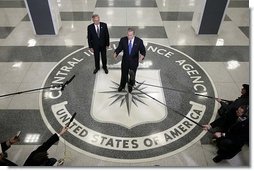 Standing on the agency seal, President George W. Bush speaks to the media inside the CIA headquarters Thursday, March 3, 2005, as CIA Director Porter Goss listens in.  White House photo by Paul Morse