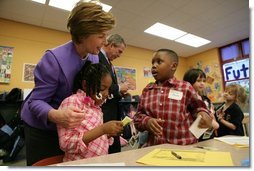 Laura Bush talks with Providence Family Support Center after-school program participants Isaiah Baynes, right, and Carlaija Whitehead during her visit and President Bush's to Pittsburgh to highlight the program's efforts to help area youth Monday, March 7, 2005.  White House photo by Susan Sterner