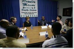 Laura Bush Secretary of Health and Human Services Mike Leavitt listen to Alphonso Pettis, Case Manager for Today's Dad's at Rosalie Manor Community and Family Services center in Milwaukee, Wis, Tuesday, March 8, 2005. Mr. Pettis is explaining in detail the pride he feels regarding the achievements of the young men sitting at the table, who, as teen fathers, have finished high school and found jobs.  White House photo by Susan Sterner