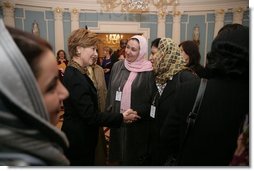 Laura Bush greets Afghan Ministers during her visit to the State Department for an International Women's Day Forum in Washington, D.C., Tuesday, March 8, 2005.  White House photo by Susan Sterner