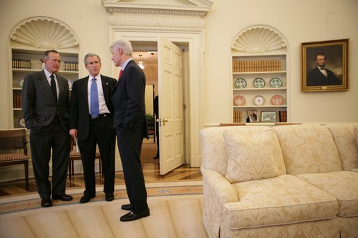 President George W. Bush listens to a report from former President George H. W. Bush and former President Bill Clinton on their recent tour of Asian nations hit by the Dec. 26, 2004 tsunami. White House photo by Eric Draper