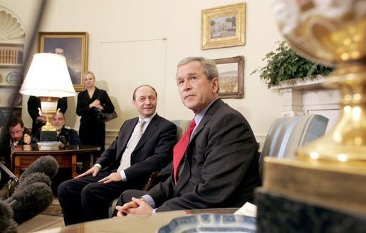 President George W. Bush and Romanian President Traian Basescu take questions from the media in the Oval Office Wednesday, March 9, 2005. White House photo by Paul Morse