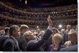 President George W. Bush waves to people in the balconies after participating in a conversation on strengthening Social Security at the Cannon Center for the Performing Arts in Memphis, Tenn., Friday, March 11, 2005.  White House photo by Paul Morse