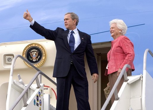 Before departing Pensacola en route Orlando, Fla., President George W. Bush gives a thumbs up sign while boarding Air Force One with his mother Barbara Bush Friday, March 18, 2005. White House photo by Eric Draper