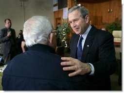 President George W. Bush talks with a retiree during a visit to The Life Project Senior Development Center in Orlando, Fla. Friday, March 18, 2005.  White House photo by Eric Draper