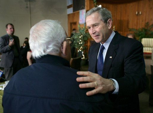 President George W. Bush talks with a retiree during a visit to The Life Project Senior Development Center in Orlando, Fla. Friday, March 18, 2005. White House photo by Eric Draper