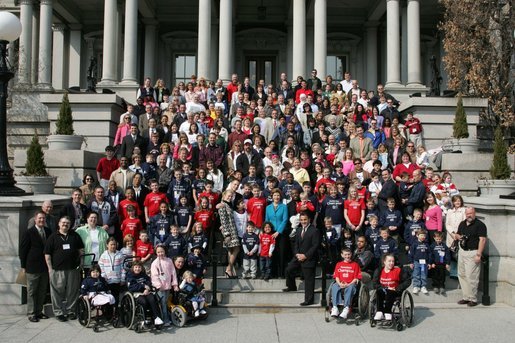 Laura Bush stands with country singer LeAnn Rimes, actor LeVar Burton and representatives of the Children's Miracle Network on the steps of the Dwight D. Eisenhower Executive Office Building near the White House Friday, March 18, 2005. White House photo by Susan Sterner