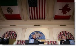 President George W. Bush participates in a March 23, 2005, joint news conference with Mexican President Vicente Fox, left, and Canadian Prime Minister Paul Martin, right, at Baylor University in Waco, Texas. "And I appreciate the commitment of the Prime Minister and the President toward a spirit of partnership to outlast whatever politics may occur; that puts in place a firm commitment to markets and democracy and freedom and trade and mutual prosperity and mutual security," said President Bush.  White House photo by Eric Draper