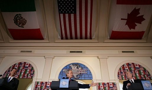 President George W. Bush participates in a March 23, 2005, joint news conference with Mexican President Vicente Fox, left, and Canadian Prime Minister Paul Martin, right, at Baylor University in Waco, Texas. "And I appreciate the commitment of the Prime Minister and the President toward a spirit of partnership to outlast whatever politics may occur; that puts in place a firm commitment to markets and democracy and freedom and trade and mutual prosperity and mutual security," said President Bush. White House photo by Eric Draper White House photo by Eric Draper