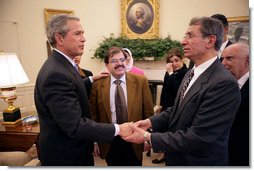 Meeting with citizens from Iraq, President George W. Bush talks with Maurice Shohet and Ali Alattar, center, in the Oval Office Tuesday, March 29, 2005.  White House photo by Eric Draper