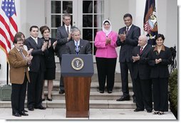 Accompanied by Iraqi citizens who voted in the recent elections, President George W. Bush delivers remarks about freedom in Iraq in the Rose Garden Tuesday, March 29, 2005. "I want to thank you for your strong belief in democracy and freedom. It's a belief that, with their vote, the Iraqi people signal to the world that they intend to claim their liberty and build a future of freedom for their country," said President Bush. "And it was a powerful signal."  White House photo by Eric Draper