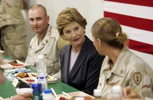 Laura Bush joins US troops as they dine in the Dragon Chow Dining Hall on Bagram Air Base in Kabul, Afghanistan Wednesday, March 30, 2005. White House photo by Susan Sterner