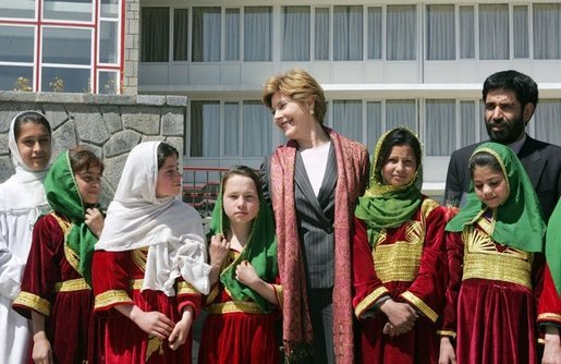 Mrs. Laura Bush stands with a group of Afghan girls on hand to greet her Wednesday, March 30, 2005, upon her arrival in Kabul. White House photo by Susan Sterner