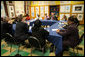 The President and Mrs. Bush sit among children of prisoners, their mentors and administrators Friday, April 1, 2005, during a roundtable discussion at Paul Public Charter School in Washington DC. The president met with the kids and others as part of his Helping America's Youth initiative. White House photo by Eric Draper