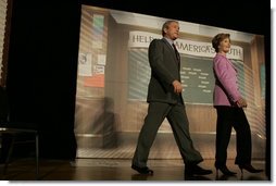 The President and Mrs. Bush arrive on stage at Paul Public Charter School in Washington DC Friday, April 1, 2005. The first lady introduced the president who spoke to the audience about his Helping America's Youth initiative.  White House photo by Krisanne Johnson