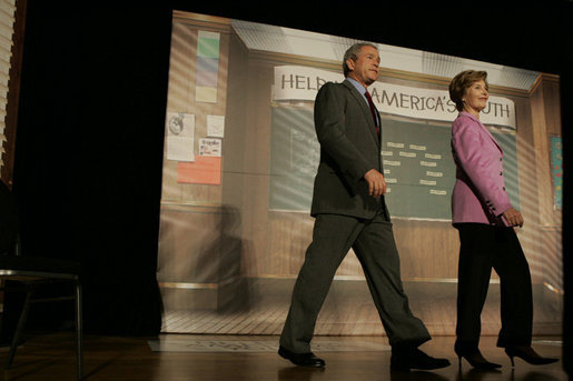 The President and Mrs. Bush arrive on stage at Paul Public Charter School in Washington DC Friday, April 1, 2005. The first lady introduced the president who spoke to the audience about his Helping America's Youth initiative. White House photo by Krisanne Johnson